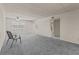 Cozy living room featuring plush carpet, ceiling fan, and access to the bathroom at 11620 Park Blvd # 306, Seminole, FL 33772