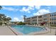 Community pool surrounded by lounge chairs, offering a relaxing and refreshing outdoor experience at 11620 Park Blvd # 306, Seminole, FL 33772