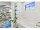 Bright bathroom featuring a tiled bathtub and a doorway into the bedroom at 13019 Wildflower Meadow Dr, Riverview, FL 33579