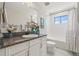 Well-lit bathroom featuring a vanity with granite countertops and a shower-tub combination at 13019 Wildflower Meadow Dr, Riverview, FL 33579