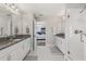 Symmetrical bathroom featuring dual vanities with granite countertops and a view into the main bedroom at 13019 Wildflower Meadow Dr, Riverview, FL 33579