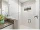 Modern bathroom featuring glass shower with white tiling, granite counter and decorative plant at 13019 Wildflower Meadow Dr, Riverview, FL 33579