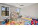 Bright room with a colorful map rug, drum set, and toy storage at 13019 Wildflower Meadow Dr, Riverview, FL 33579