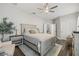 Cozy bedroom with a queen-sized bed, nightstands, natural light, and hardwood floors at 13019 Wildflower Meadow Dr, Riverview, FL 33579