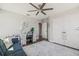 Bright bedroom featuring a ceiling fan, a desk nook, and an adjacent doorway at 13019 Wildflower Meadow Dr, Riverview, FL 33579