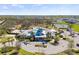 Aerial view of the clubhouse featuring pools, tennis courts, and well-maintained landscaping at 13019 Wildflower Meadow Dr, Riverview, FL 33579