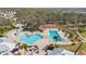 Aerial view of a resort-style community pool featuring a splash pad, and lounge chairs at 13019 Wildflower Meadow Dr, Riverview, FL 33579