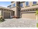 A three car garage with brick driveway, exterior elevation at 13019 Wildflower Meadow Dr, Riverview, FL 33579