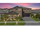 Beautiful two-story home featuring a well-manicured lawn, elegant landscaping, and a paver driveway at 13019 Wildflower Meadow Dr, Riverview, FL 33579