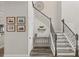 Welcoming foyer showcasing staircase with decorative console table and artwork at 13019 Wildflower Meadow Dr, Riverview, FL 33579