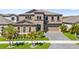 Stunning exterior with well-manicured landscaping, a paver driveway and a two-car garage at 13019 Wildflower Meadow Dr, Riverview, FL 33579