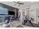 Bright home gym featuring a variety of workout equipment and wood accent wall at 13019 Wildflower Meadow Dr, Riverview, FL 33579