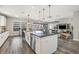 Open concept kitchen features a stainless farmhouse sink, center island, and breakfast bar seating at 13019 Wildflower Meadow Dr, Riverview, FL 33579