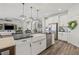 A bright kitchen with stainless steel appliances, a farmhouse sink, and stylish pendant lighting over the island at 13019 Wildflower Meadow Dr, Riverview, FL 33579