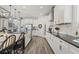 Modern kitchen with stainless steel appliances, bar stools, and white cabinets at 13019 Wildflower Meadow Dr, Riverview, FL 33579