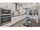 Modern kitchen featuring stainless steel appliances, white cabinets, subway tile backsplash, and black countertops at 13019 Wildflower Meadow Dr, Riverview, FL 33579