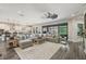 Open-concept living room adjacent to kitchen featuring a ceiling fan, recessed lights, and hardwood floors at 13019 Wildflower Meadow Dr, Riverview, FL 33579