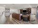 Open-concept living room with hardwood floors, comfortable seating, and built-in bookshelves at 13019 Wildflower Meadow Dr, Riverview, FL 33579