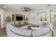 Bright and airy living room with large sectional sofa, custom built-ins, and stylish ceiling fan at 13019 Wildflower Meadow Dr, Riverview, FL 33579