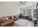 Comfortable living room features a brown leather sofa, light gray rug and an abundance of natural light at 13019 Wildflower Meadow Dr, Riverview, FL 33579