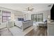 Serene main bedroom featuring a king-size bed, windows with natural light, and outdoor access at 13019 Wildflower Meadow Dr, Riverview, FL 33579