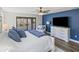 Stylish bedroom featuring a TV, chaise lounge, and access to the screened patio at 13019 Wildflower Meadow Dr, Riverview, FL 33579