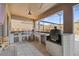 Covered outdoor kitchen featuring stainless appliances, a beverage cooler, and a barbecue grill at 13019 Wildflower Meadow Dr, Riverview, FL 33579