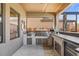Outdoor kitchen with stainless steel appliances, a built-in grill, and a bar area at 13019 Wildflower Meadow Dr, Riverview, FL 33579