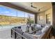 Beautiful outdoor living space with comfortable seating, ceiling fan, and serene views at 13019 Wildflower Meadow Dr, Riverview, FL 33579