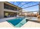 An amazing outdoor space with a kitchen, a bar, a pool, and lots of room for entertaining at 13019 Wildflower Meadow Dr, Riverview, FL 33579