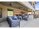 Covered patio features a large seating area, an outdoor kitchen, a bar and easy access to the home's interior at 13019 Wildflower Meadow Dr, Riverview, FL 33579