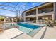 Relaxing outdoor living space with pool, hot tub, outdoor seating and outdoor kitchen with bar at 13019 Wildflower Meadow Dr, Riverview, FL 33579