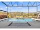 Sparkling pool with attached spa overlooking a beautifully landscaped backyard in a screened-in lanai at 13019 Wildflower Meadow Dr, Riverview, FL 33579