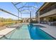 Gorgeous pool with a spa and an outdoor fireplace in a screened-in lanai at 13019 Wildflower Meadow Dr, Riverview, FL 33579