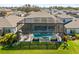 Screened pool with integrated spa, patio area and outdoor kitchen in a private backyard at 13019 Wildflower Meadow Dr, Riverview, FL 33579