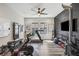 Home workout room featuring a ceiling fan, mounted TV, and various exercise machines at 13019 Wildflower Meadow Dr, Riverview, FL 33579