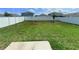 Large backyard featuring green lawn and a full perimeter fence for privacy at 13118 Zolo Springs Cir, Riverview, FL 33579