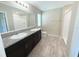 Modern bathroom featuring a double vanity with granite countertops, wood look floors and tiled shower at 13118 Zolo Springs Cir, Riverview, FL 33579