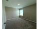 Empty bedroom featuring neutral walls, carpet, and a window that lets in natural light at 13118 Zolo Springs Cir, Riverview, FL 33579