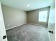 Neutral bedroom featuring carpet, tan walls and a window for lots of natural light at 13118 Zolo Springs Cir, Riverview, FL 33579