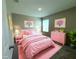 Pink bedroom with a comfy bed, bright decor, and plush rug at 13118 Zolo Springs Cir, Riverview, FL 33579