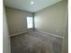 Empty bedroom with neutral carpet and a window at 13118 Zolo Springs Cir, Riverview, FL 33579