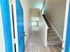Bright foyer with carpeted stairs and views into the main living area at 13118 Zolo Springs Cir, Riverview, FL 33579