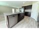 Kitchen island with granite countertops and stainless steel dishwasher at 13118 Zolo Springs Cir, Riverview, FL 33579