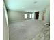 Open-concept living area with neutral paint, carpet, and natural light at 13118 Zolo Springs Cir, Riverview, FL 33579