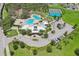 Overhead shot displays community pool, clubhouse, tennis courts, and meticulously landscaped grounds at 13128 Foxtail Fern Dr, Riverview, FL 33579