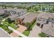 Aerial view of a single-story home featuring a paver driveway, well-kept lawn, and tropical landscaping at 13128 Foxtail Fern Dr, Riverview, FL 33579