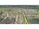 Expansive aerial view of a well-planned community featuring interconnected lakes and lush green spaces at 13128 Foxtail Fern Dr, Riverview, FL 33579