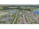 Wide aerial view of a vibrant residential area featuring multiple ponds and orderly street layouts at 13128 Foxtail Fern Dr, Riverview, FL 33579