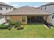 Enjoy outdoor living in this backyard with a patio, lush green lawn, and privacy fence at 13128 Foxtail Fern Dr, Riverview, FL 33579